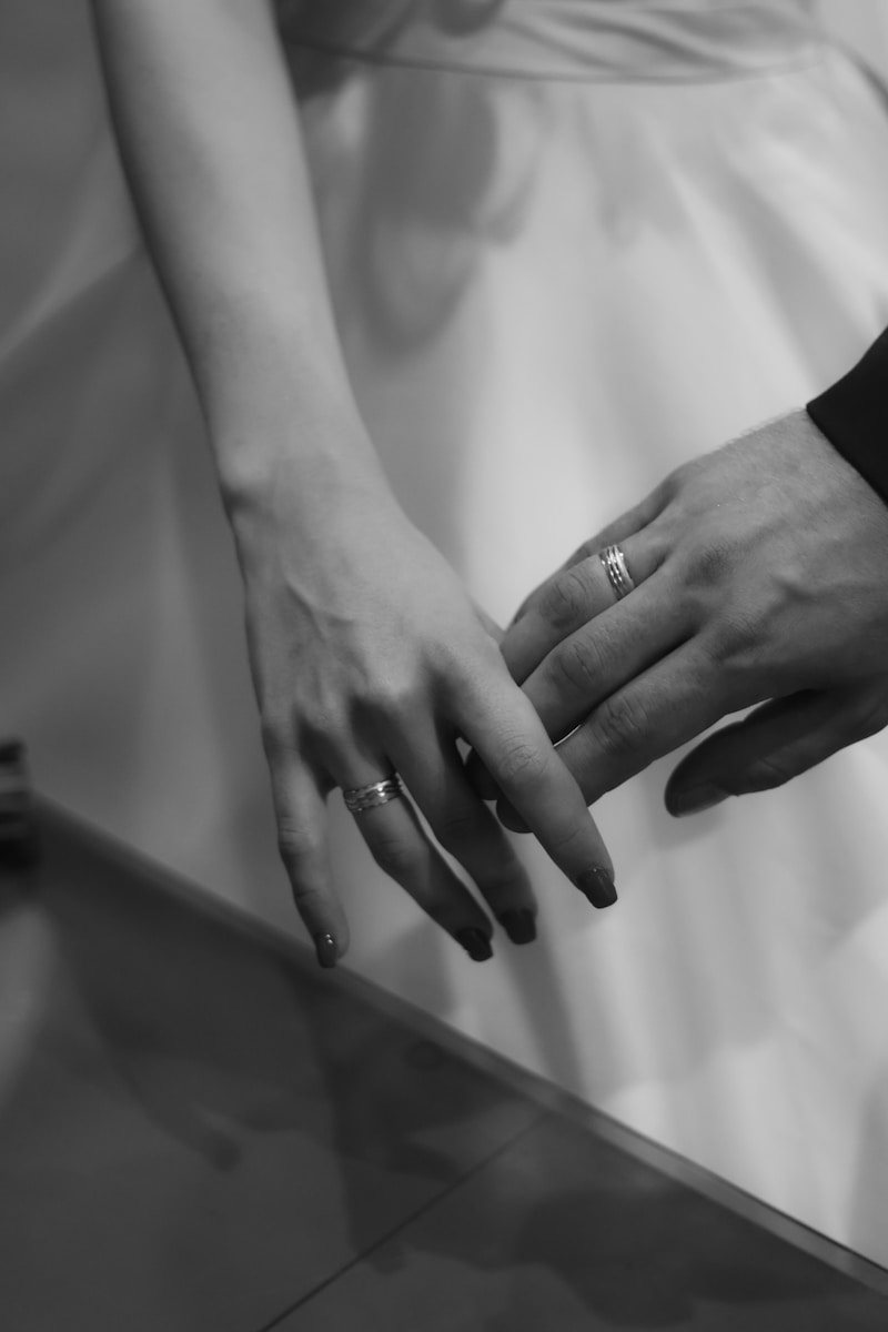 A close up of two people holding hands